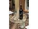 Stylishly set table featuring a bottle of wine, decorative objects, and glassware at 3209 Sedgefield Rd, Statesville, NC 28625