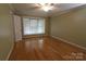 Bright bedroom features hardwood floors, a ceiling fan, and a large bay window for ample natural light at 344 Lucas Rd, Star, NC 27356
