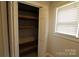 Open closet with built-in shelving providing organized storage space, next to a window at 344 Lucas Rd, Star, NC 27356