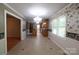 Sunlit dining room with tile floors, decorative wallpaper, and open view to the kitchen at 344 Lucas Rd, Star, NC 27356