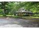 Charming home nestled among mature trees and lush landscaping in a wooded lot at 344 Lucas Rd, Star, NC 27356