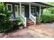 Inviting front porch with rocking chairs and brick walkway adding character and charm at 344 Lucas Rd, Star, NC 27356