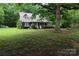 Charming home with a covered front porch and mature trees in a beautiful landscaped yard at 344 Lucas Rd, Star, NC 27356