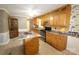 Well-lit kitchen with oak cabinets, stainless steel appliances, and a central island at 344 Lucas Rd, Star, NC 27356