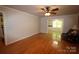 Bright living room with hardwood floors, ceiling fan, and a glimpse into the adjacent room at 344 Lucas Rd, Star, NC 27356