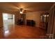 Inviting living room featuring hardwood floors, fireplace, and an open floor plan to a sunroom at 344 Lucas Rd, Star, NC 27356