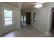 Cozy sunroom area with brick accent wall, tile floors, and large windows, enhancing the space's appeal at 344 Lucas Rd, Star, NC 27356
