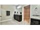 This bathroom features granite countertops, dark wood cabinetry and access to a walk in closet at 3735 Norman View Dr, Sherrills Ford, NC 28673
