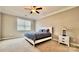 This bedroom features neutral walls, carpet flooring, ceiling fan and a large window to offer natural light at 3735 Norman View Dr, Sherrills Ford, NC 28673