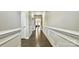 Long hallway with hardwood floors and detailed trim work leads to the home's living areas at 3735 Norman View Dr, Sherrills Ford, NC 28673