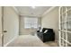 A well-lit home office with carpeted floors and a comfortable couch at 3735 Norman View Dr, Sherrills Ford, NC 28673