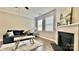 The inviting living room offers a ceiling fan, fireplace and a large window to offer plenty of natural light at 3735 Norman View Dr, Sherrills Ford, NC 28673