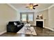The inviting living room offers a ceiling fan, fireplace and a large window to offer plenty of natural light at 3735 Norman View Dr, Sherrills Ford, NC 28673