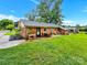 Backyard view of the home with patio area, seating and a well-maintained lawn at 4108 Mellon Rd, Matthews, NC 28104