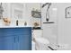 Bathroom featuring a glass enclosed shower, blue vanity and neutral decor at 4108 Mellon Rd, Matthews, NC 28104