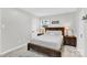 Serene bedroom with a rustic wood bed frame, side tables with lamps, and a bright window at 4108 Mellon Rd, Matthews, NC 28104