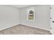 Empty bedroom with neutral walls, wood floors and a window overlooking the yard at 4108 Mellon Rd, Matthews, NC 28104