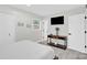 Comfortable bedroom with simple decor, a mounted TV, and a serene atmosphere at 4108 Mellon Rd, Matthews, NC 28104