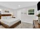 Inviting bedroom featuring a comfortable bed, a nightstand with a lamp, and a view of a sunny window at 4108 Mellon Rd, Matthews, NC 28104