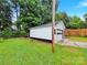 Detached garage with white siding and a roll-up door, providing ample parking and storage space at 4108 Mellon Rd, Matthews, NC 28104