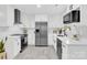 Modern kitchen with sleek white cabinets, stainless steel appliances, and elegant countertops at 4108 Mellon Rd, Matthews, NC 28104