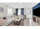 Bright living room featuring neutral colors, modern decor, and lots of natural light streaming through the windows at 4108 Mellon Rd, Matthews, NC 28104