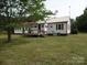Back of home featuring a sunroom, a deck, and a white exterior at 5004 King Wilkinson Rd, Denver, NC 28037