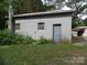 Detached garage made from cinderblocks with a grey door at 5004 King Wilkinson Rd, Denver, NC 28037