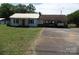 Charming single-Gathering home with a metal roof, carport, and mature trees at 5004 King Wilkinson Rd, Denver, NC 28037