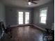 Living room featuring laminate floors, neutral walls, a ceiling fan, and a window at 5004 King Wilkinson Rd, Denver, NC 28037