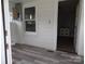 Sunroom featuring laminate floors, neutral walls, and lots of light from the windows at 5004 King Wilkinson Rd, Denver, NC 28037
