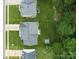 An aerial shot displays well-maintained backyards and rooftops surrounded by lush greenery and nearby woods at 5748 Timbertop Ln, Charlotte, NC 28215