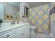 Well-lit bathroom with a vanity, mirror, and a decorative shower curtain at 5748 Timbertop Ln, Charlotte, NC 28215