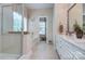 Spacious bathroom featuring a glass shower, separate tub, and double sink at 5748 Timbertop Ln, Charlotte, NC 28215