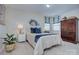 Stylish bedroom with a plush bed, decorative pillows, and a wooden dresser at 5748 Timbertop Ln, Charlotte, NC 28215