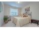 Comfortable bedroom with a plush bed, decorative pillows, and a cozy chair at 5748 Timbertop Ln, Charlotte, NC 28215