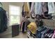 Organized walk-in closet with shelving and hanging rods, flooded with natural light from the window at 5748 Timbertop Ln, Charlotte, NC 28215