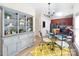 Stylish dining area adjacent to the kitchen with a decorative hutch and modern dining set on wood flooring at 5748 Timbertop Ln, Charlotte, NC 28215