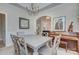 This dining room features stylish lighting, a piano, and elegant artwork at 5748 Timbertop Ln, Charlotte, NC 28215