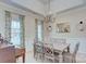 The dining room features a large table and chairs plus a piano and lots of natural light at 5748 Timbertop Ln, Charlotte, NC 28215