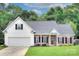 Charming home with a well-manicured lawn, brick accents, and an attached two-car garage at 5748 Timbertop Ln, Charlotte, NC 28215