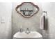 Small half bath features wallpaper, a mirror, and a towel rack at 5748 Timbertop Ln, Charlotte, NC 28215
