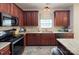 Well-equipped kitchen featuring wooden cabinets, stone countertops, and modern appliances for culinary enthusiasts at 5748 Timbertop Ln, Charlotte, NC 28215