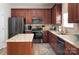 Charming kitchen with wooden cabinets, stainless steel appliances, and a granite countertop island at 5748 Timbertop Ln, Charlotte, NC 28215