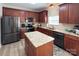Modern kitchen with stainless steel appliances, granite countertops, and a central island for food preparation at 5748 Timbertop Ln, Charlotte, NC 28215