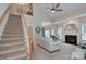 Spacious living room featuring a fireplace, vaulted ceilings, and direct access to the upper floor at 5748 Timbertop Ln, Charlotte, NC 28215