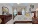 The primary bedroom features matching furniture, neutral paint, and lots of natural light at 5748 Timbertop Ln, Charlotte, NC 28215