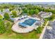 Aerial view of the community pool area with lounge areas, covered tables and blue umbrellas surrounded by lush greenery at 5836 Clan Maclaine Dr, Charlotte, NC 28278