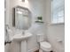 Updated half-bathroom with a large mirror, vessel sink, and decorative accents at 5836 Clan Maclaine Dr, Charlotte, NC 28278