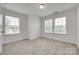 Carpeted bedroom with three windows bringing in natural light at 5836 Clan Maclaine Dr, Charlotte, NC 28278